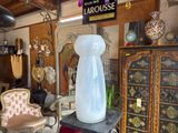 a glass vase sitting on top of a table in a room