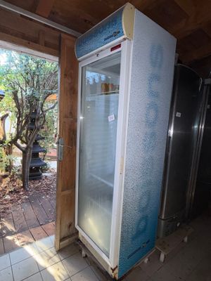 a refrigerator that is in the middle of a room