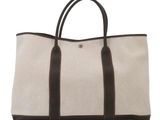 a white and brown tote bag sitting on top of a white surface