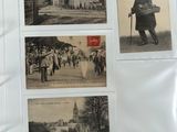 an old photo of a man walking down a street with a bunch of pictures on it