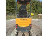 the back end of a small construction vehicle parked in a parking lot