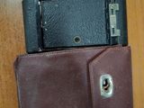 a wallet with a cell phone in it on a table