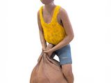 a clay figurine of a boy sitting on top of a bag