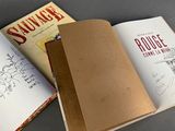two books that are open on a table