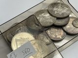 coins in a clear box with a price tag on it