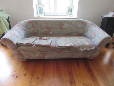 a couch that is sitting on a hard wood floor