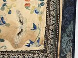 a close up of a piece of cloth with flowers and birds on it
