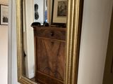 a mirror hanging on the wall in a hallway
