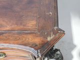 a close up of a wooden table with a clock on it