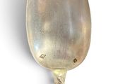 a spoon that is sitting on a white surface