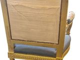 an image of a gold chair with a blue cushion on it