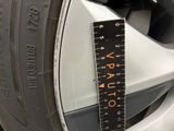 a measuring tape on the rim of a car
