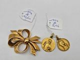 two pieces of gold jewelry with a ribbon and a medal