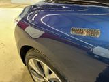 a close up of a blue car with a sticker on it