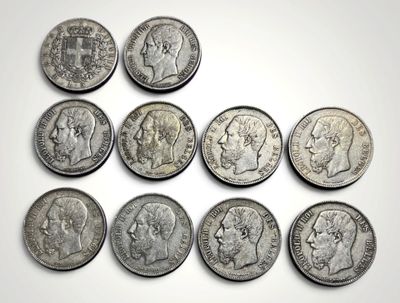 un gros plan sur un tas de pièces d'argent posées sur une surface blanche