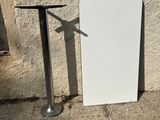 a white board leaning against a wall next to a table