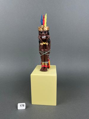 a close up of a small statue of a person on a pedestal