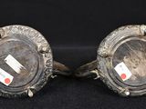 pair of antique silver plated candlesticks on black background