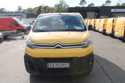 a yellow van that is parked in a parking lot