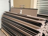 a pile of cardboard sitting on a pallet in front of a garage door