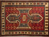 a red and blue rug with a design on it