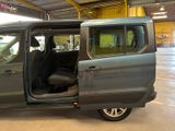 a grey van with its doors open in a garage