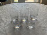 three glasses sitting on a table next to each other