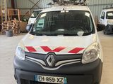 a white van with a red stripe parked in a garage