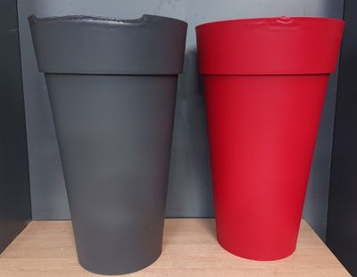 two cups that are sitting on a shelf next to each other
