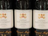 three bottles of wine are lined up on a shelf