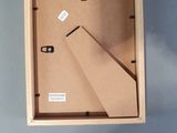 a cardboard box with a clock inside of it on a table