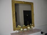 a mirror that is on a dresser in a room
