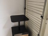 a wooden box sitting next to a metal rack in a room