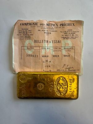gold bar with a piece of paper on it sitting on a table