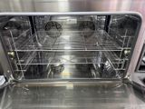 an open oven that has a lot of food inside of it
