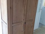 a tall wooden cabinet with a clock on top of it