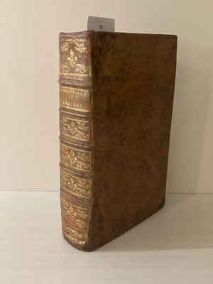 un livre marron posé sur une table blanche