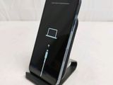 a black cell phone with a charger attached to it