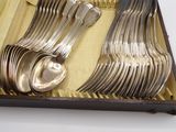 a set of silverware in a box on a table