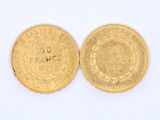 two pieces of gold coins with a white background and a white background