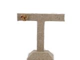 beige burlock burlock letter t with a gold star on it