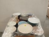 a table covered in plastic with bowls and plates on it