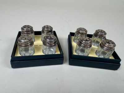 pair of silver plated salt and pepper shakers in trays
