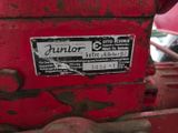 a sign on the back of a tractor that says junior
