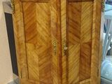 a wooden cabinet with a marble top in a room