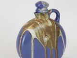 a blue and brown vase with a horse on it
