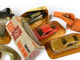 many toy cars in a box on a white surface