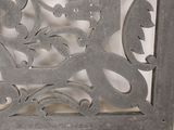 a decorative metal panel with a flower design on it