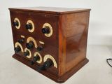 a small wooden box with many buttons on it