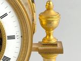 a gold clock with a black and white picture on it